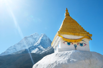 Stupa near Dingboche village with prayer flags and mounts Kangtega and Thamserku - way to mount...