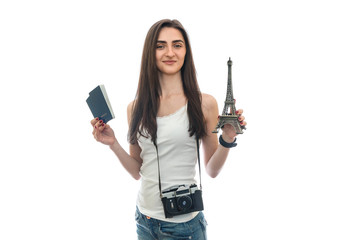 Woman with camera and passports holding eiffel tower