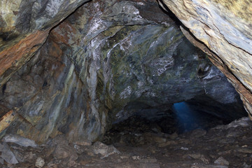 A ray of light penetrates a hole in an underground mine
