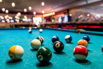 Colorful billiard balls on table in pub