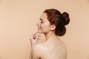 Beauty portrait of an attractive young topless redhead woman