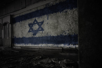 painted flag of israel on the dirty old wall in an abandoned ruined house.