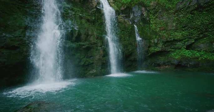 Amazing waterfall in the jungle, three waterfalls flowing in slow motion, jungle adventure vacation, natural power and beauty