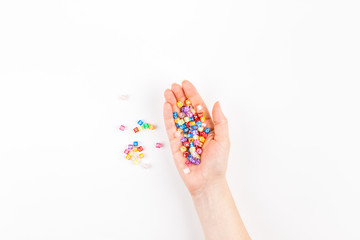 Woman hand with multicolor alphabet