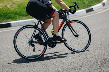 Fototapeta na wymiar Detail of a road bike with a cyclist pedaling on a road