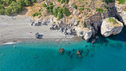 Aerial drone view of Mediterranean paradise river with palm trees flowing to sandy deep turquoise beach