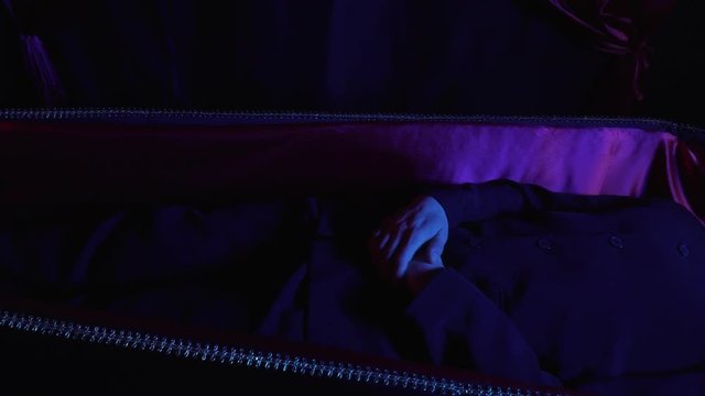 Corpse of a man is lying in the coffin, close up, 4k