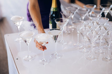 Round white table with elegant compositions from natural flowers. Banquet at the luxury wedding. Elegant design wedding table.