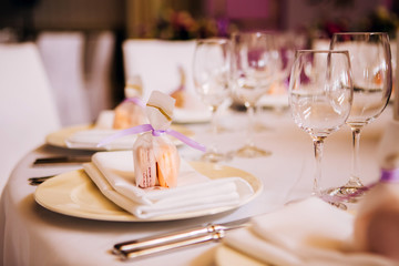 Round white table with elegant compositions from natural flowers. Banquet at the luxury wedding. Elegant design wedding table.