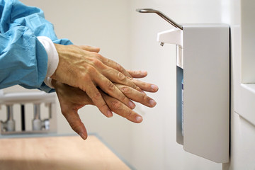 Doctor sterilizes his hands for hygiene and against hospital germs