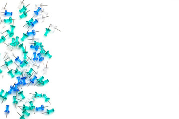 Blue, turquoise and transparent buttons laid out on the side on an isolated white background, with space for text, top view