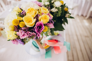 Bridal bouquet. The bride's bouquet. Bouquet of red and pink flowers. Delicate bouquet with peonies, roses and eucalyptus.