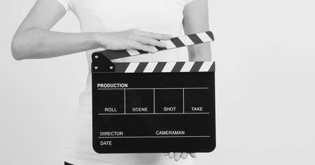 Hands is holding black Clapperboard or movie slate. it use in video production ,film, cinema...