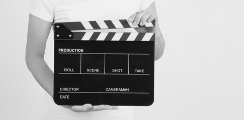 Hands is holding black Clapperboard or movie slate. it use in video production ,film, cinema...