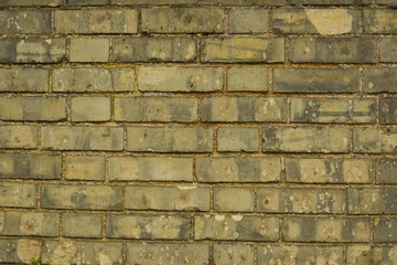 Old, yellow real stone brick wall texture, brick wall background.