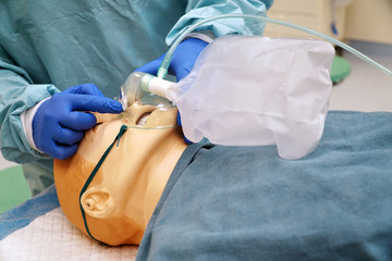 Doctor  shows the use of a non-rebreather oxygen mask using a medical patient simulator in the...
