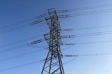 Power transmission towers against the blue sky