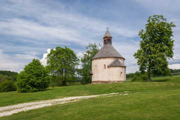 Fototapeta na wymiar Saint Nicholas and Virgin Mary rotunda near dirt road, Slovenia