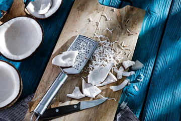 Summer fresh coconuts on blue wooden board with shadow and free space for your decoration. healthy...