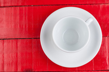 White coffee cup isolated on a red background.