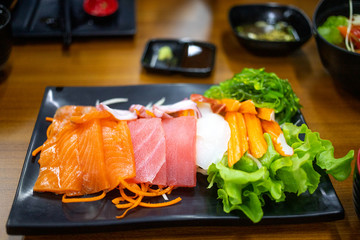 Plate of fresh salmon and tuna sashimi with vegetables,  japanese food