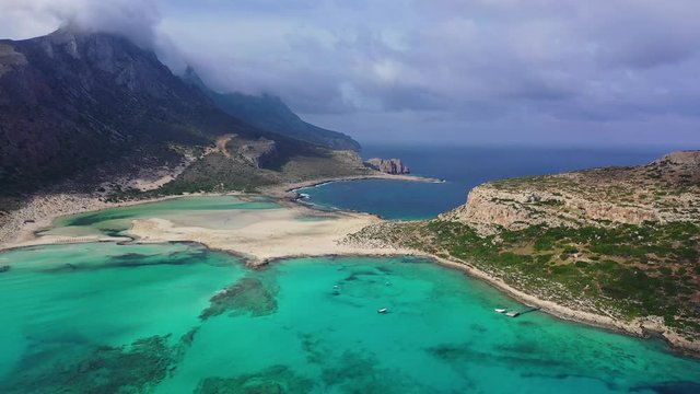 Aerial drone view video of iconic Balos beach and lagoon near Gramvousa island with turquoise clear sea and pure white sand, Crete island, Greece