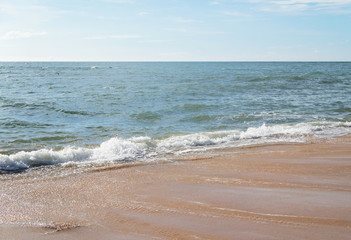 Southern tropical summer ocean coast with rocks and rocks. Lagoon with a yellow sandy beach and azure water.