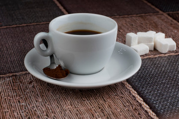 White coffee cup sugar cubes and metal spoon on table.Coffee time