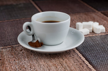 White coffee cup sugar cubes and metal spoon on table.Coffee time