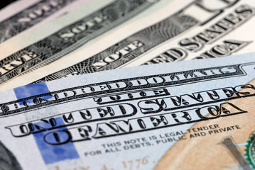 Dollar bills of different value on the table closeup. Shallow depth of field