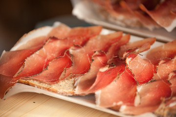 Traditional smoked speck sliced on site during the 