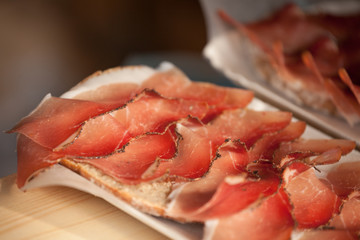 Traditional smoked speck sliced on site during the 