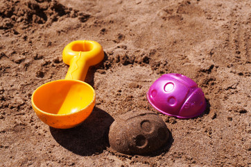 Children's toys on the sand near the shore