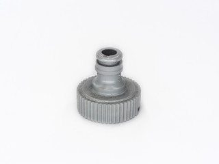 Old watering hose plastic connector shot on white.