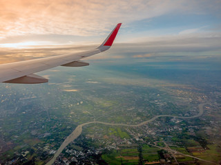 View from airplane window to see sky on  Morning sunrise with Wing of an airplane