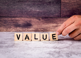 Value. Word from wooden letters. Marble table and wooden background