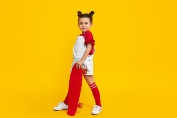 Trendy girl with red skateboard