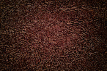 Dark brown leather texture background, closeup. Bronze cracked backdrop from wrinkle skin