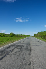 Rural asphalt road stretching to horizon