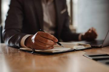 Close-up of businessman taking notes