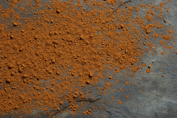 Black slate dusted with ground cocoa powder. Space for text.