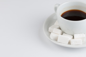 White coffee cup with sugar cubes isolated on white background.