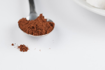 White coffee cup with sugar cubes  and metal spoon isolated on white background.