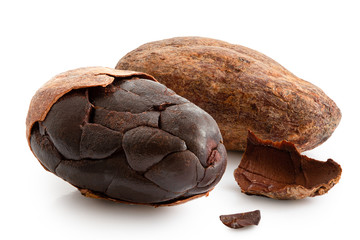One roasted partly peeled and one unpeeled cocoa bean isolated on white.