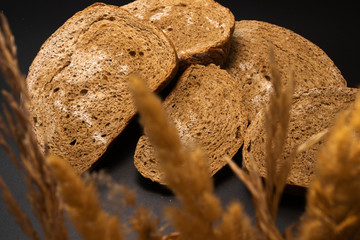 Slices of rye bread, covered with mold, with dry spikelets.