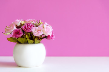 Pink wall with flower pink rose on shelf white wood, copy space for text. Still life Concept