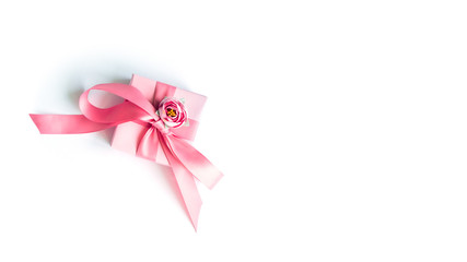 Pink gift box with a pink ribbon on a white background .