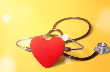 Red heart and a stethoscope on backgrouund