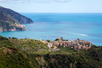 Fototapeta na wymiar Manarola / Italy - April 28 2019: View of the city of Corniglia (Cinque Terre) from the nearby hiking trails.