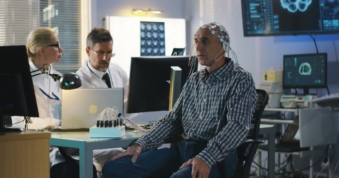 Patient answering doctors questions during brain scan
